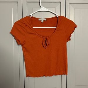 Orange ribbed shirt.